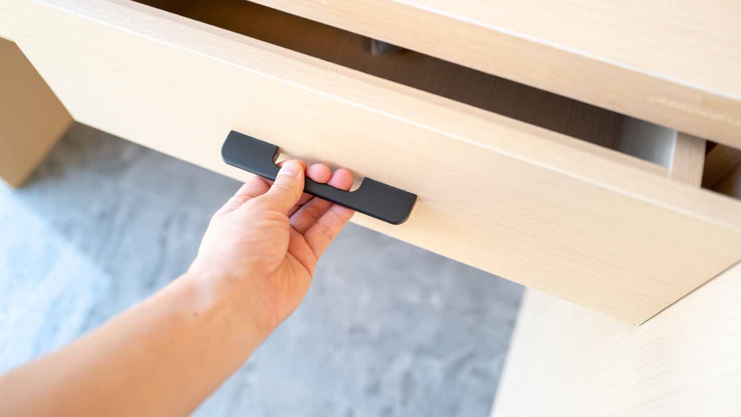 Man pulling the drawer handle