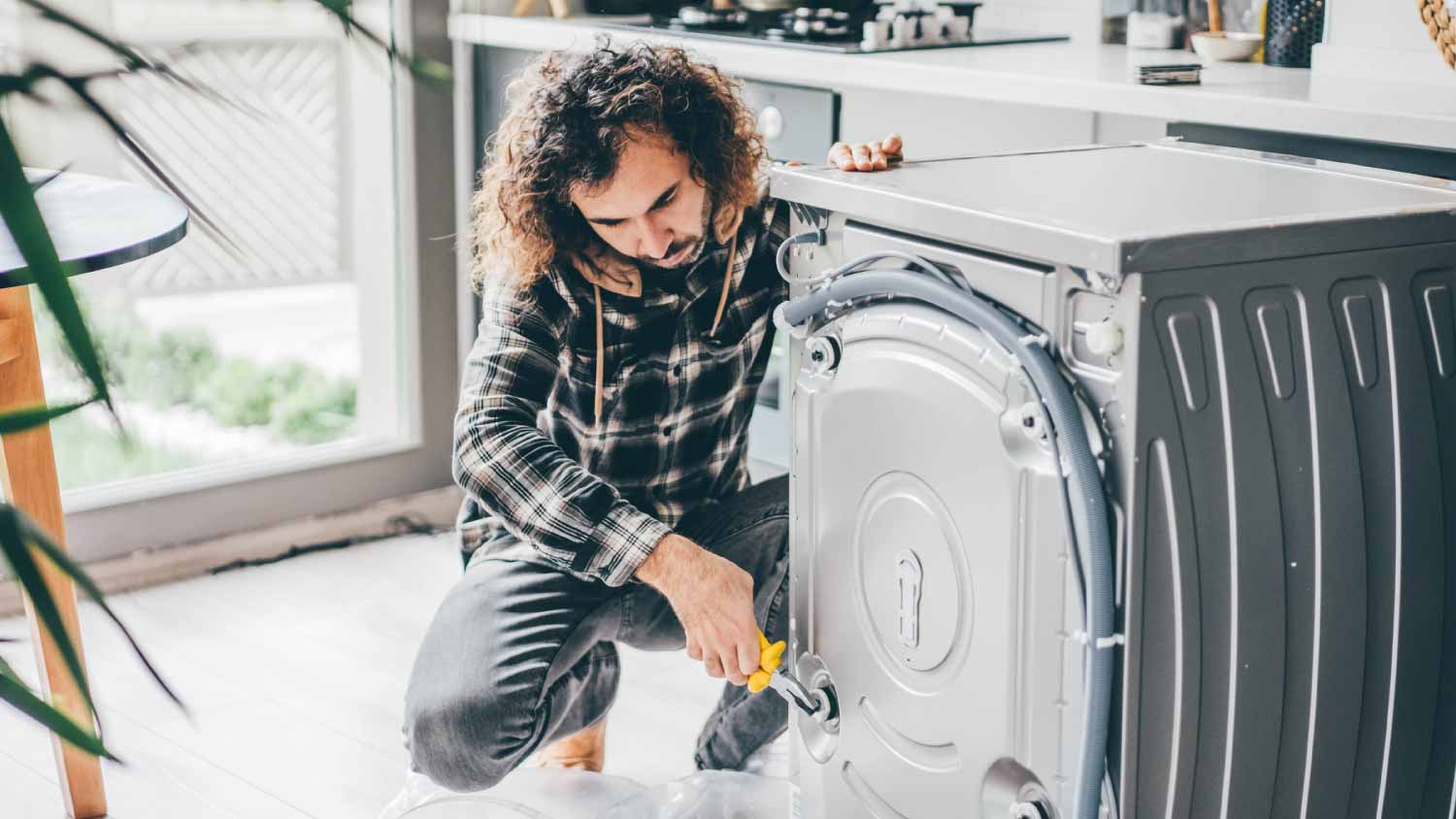 Man repairing a washing machine