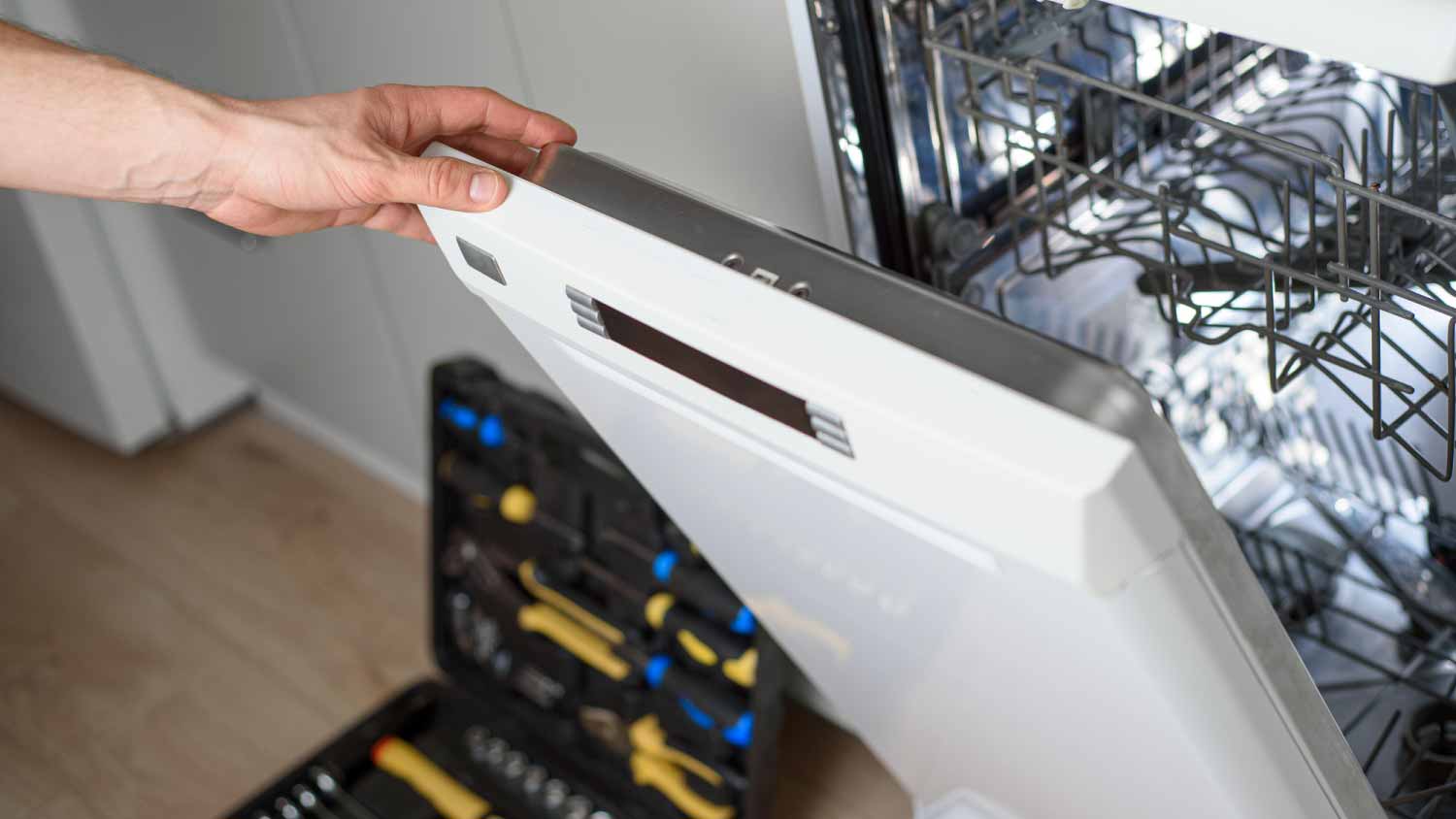 Man repairing a dishwasher