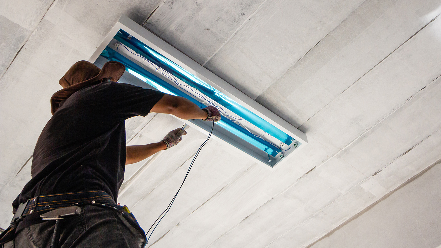 Person replacing fluorescent garage light