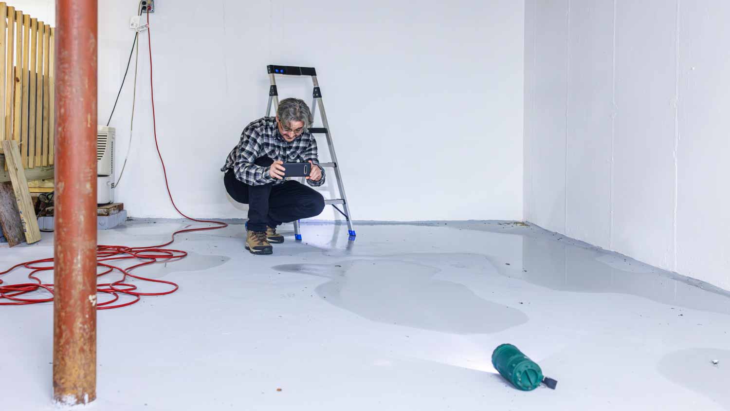 Man taking a picture of a leak