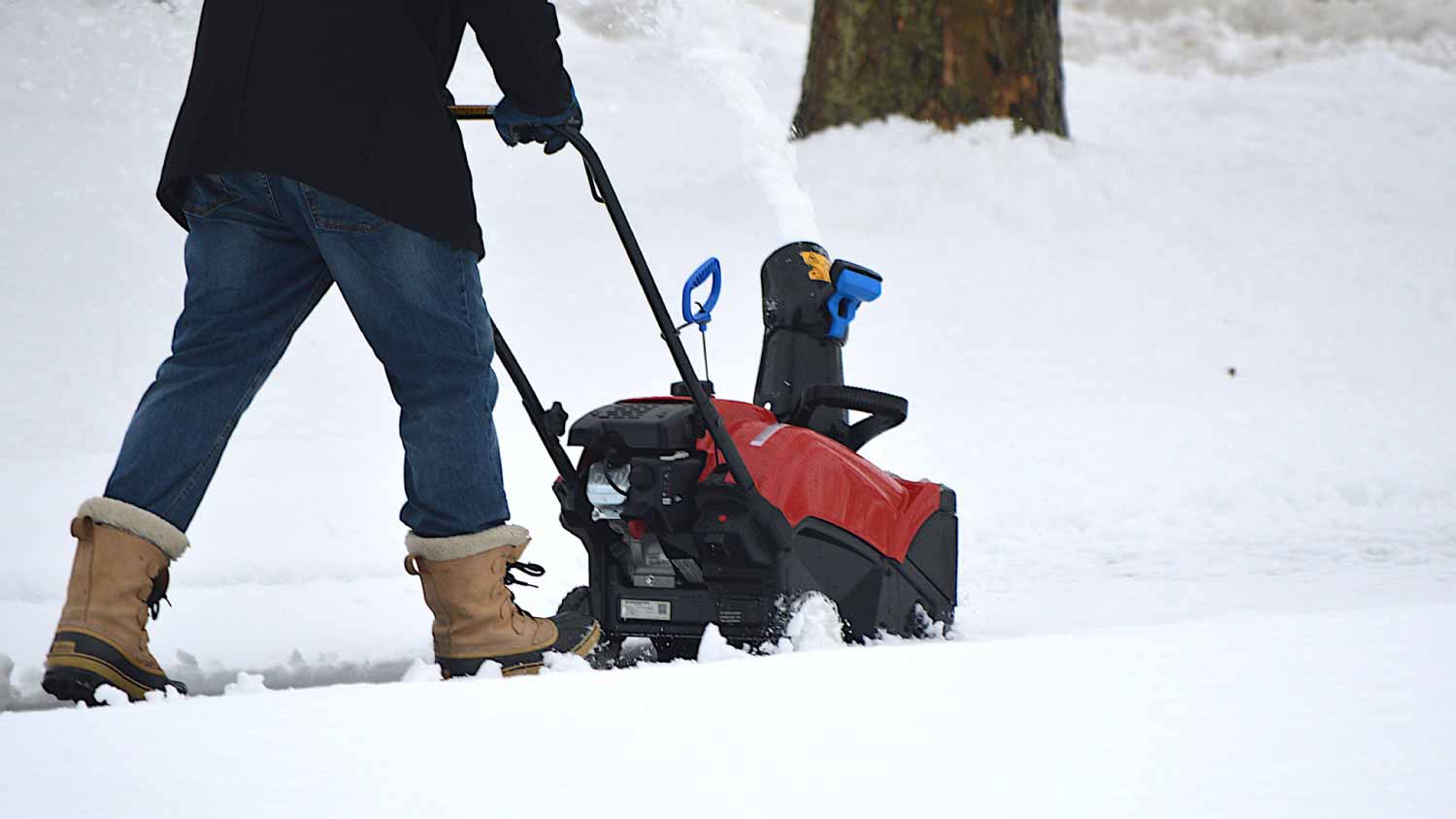 Man using electric snow blower