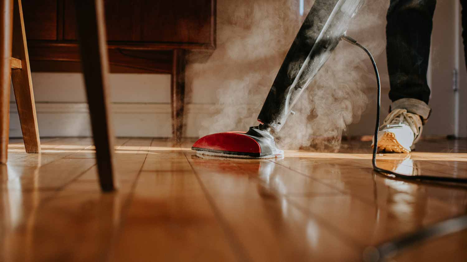 Man using an electric steam mop