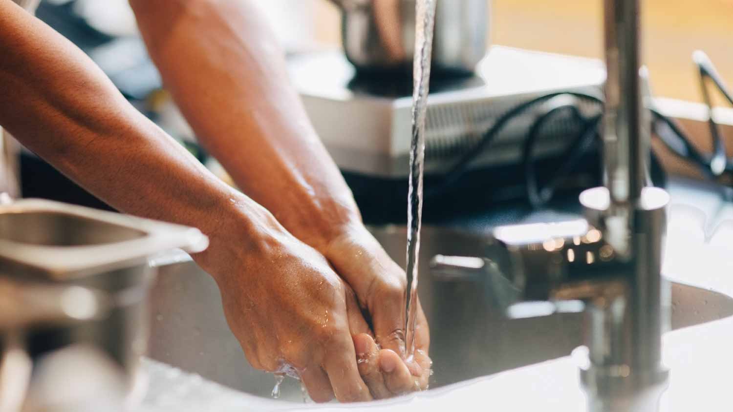 Man washing hands in sink