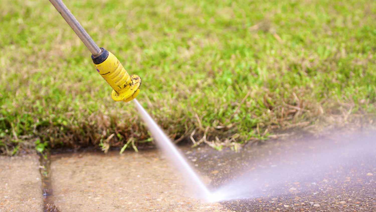 Man washing a sidewalk