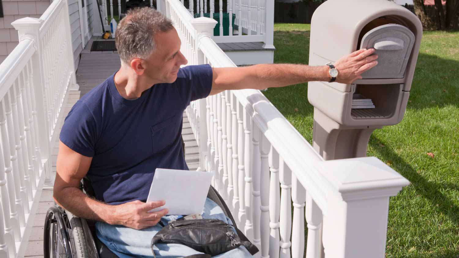 Man in a wheelchair getting his mail