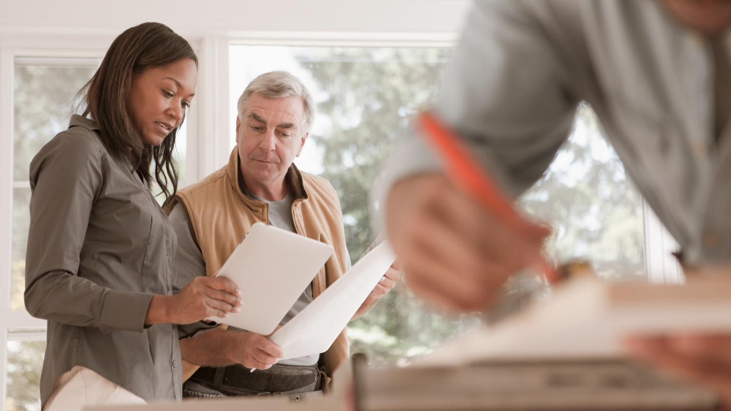 Man and woman looking at blueprints together