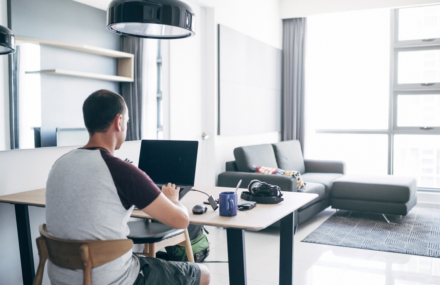 Man working at a desk in living area