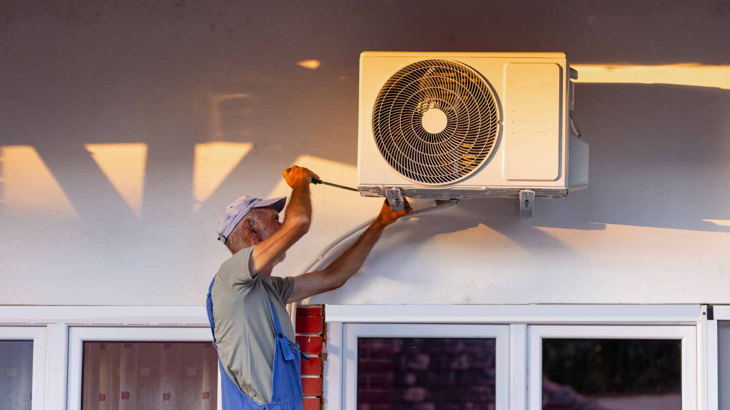 Man working on an outdoor AC unit