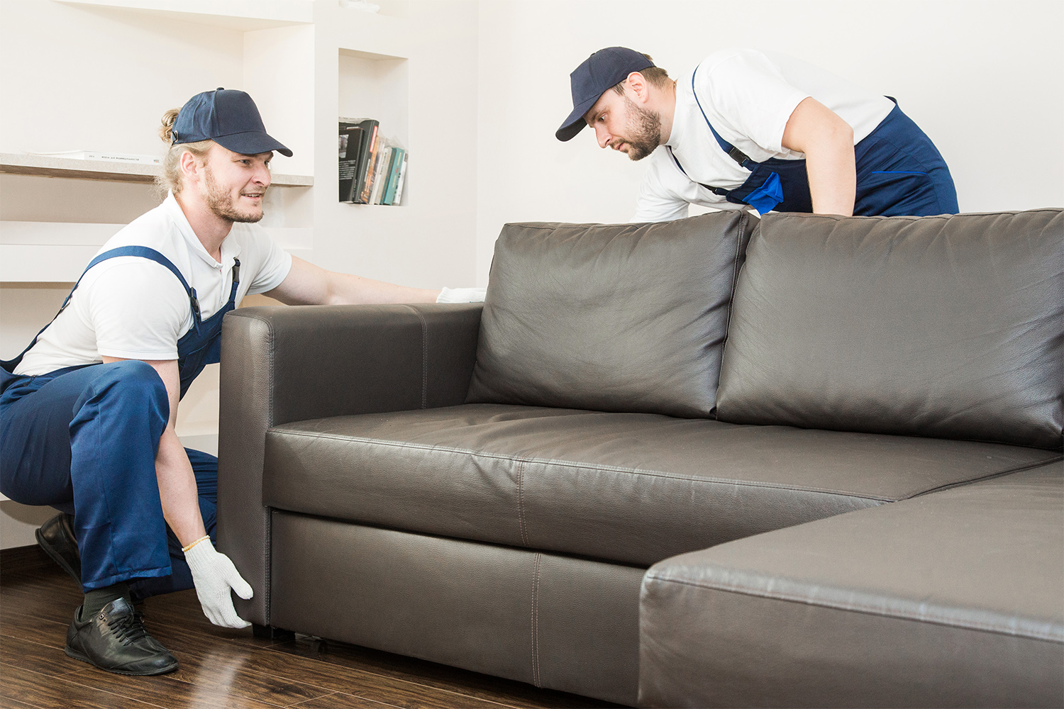 Junk removal men taking a couch away