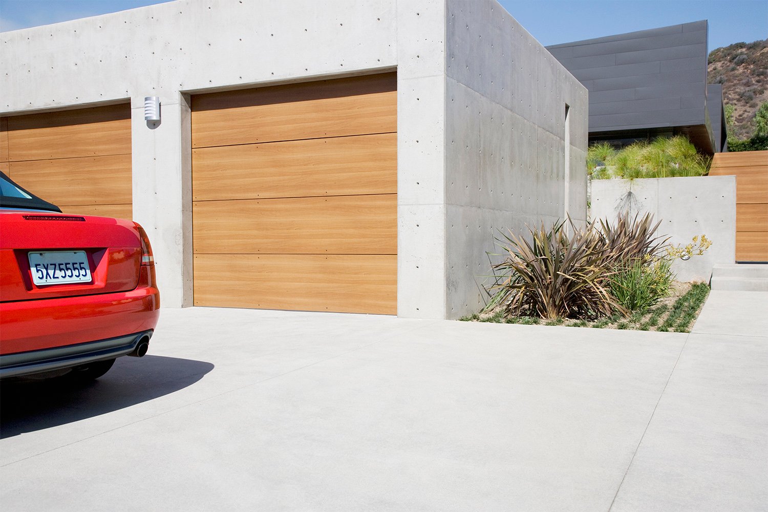 Modern garage with car on a concrete driveway