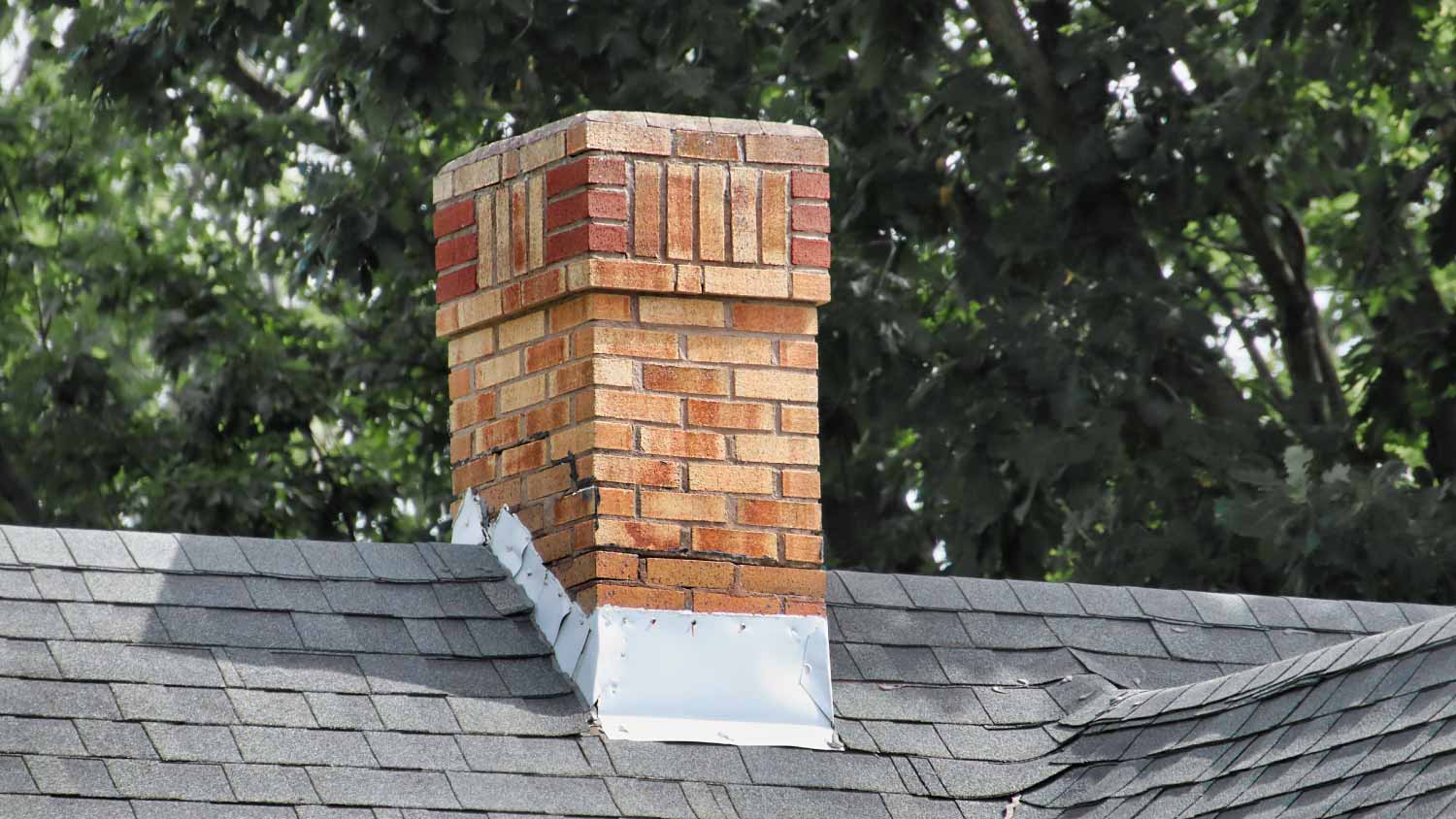 Old chimney on a shingles roof