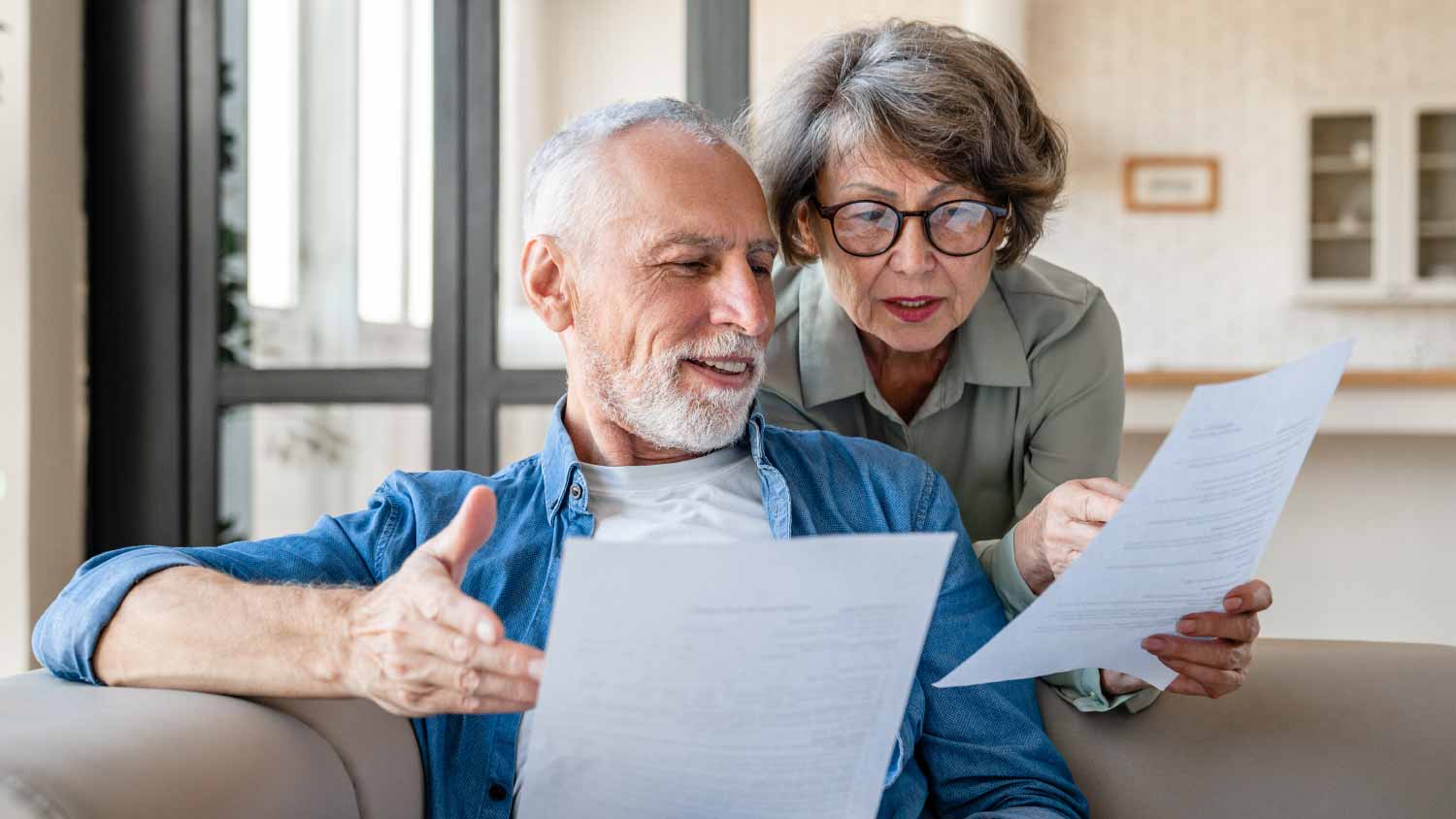 Old couple checking bills