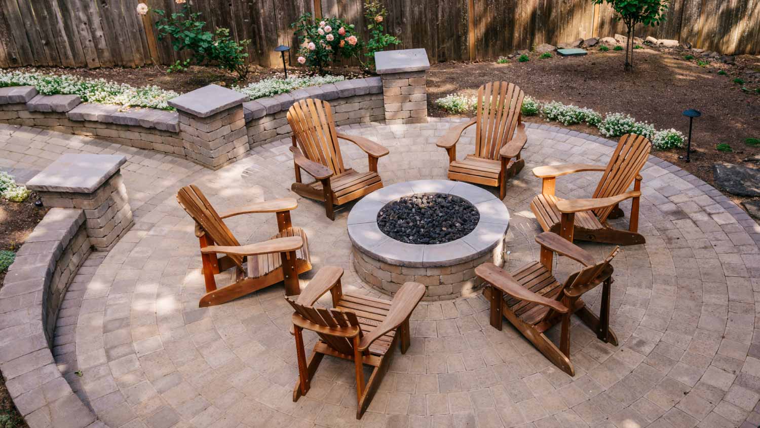 Outdoor fire pit with wooden chairs