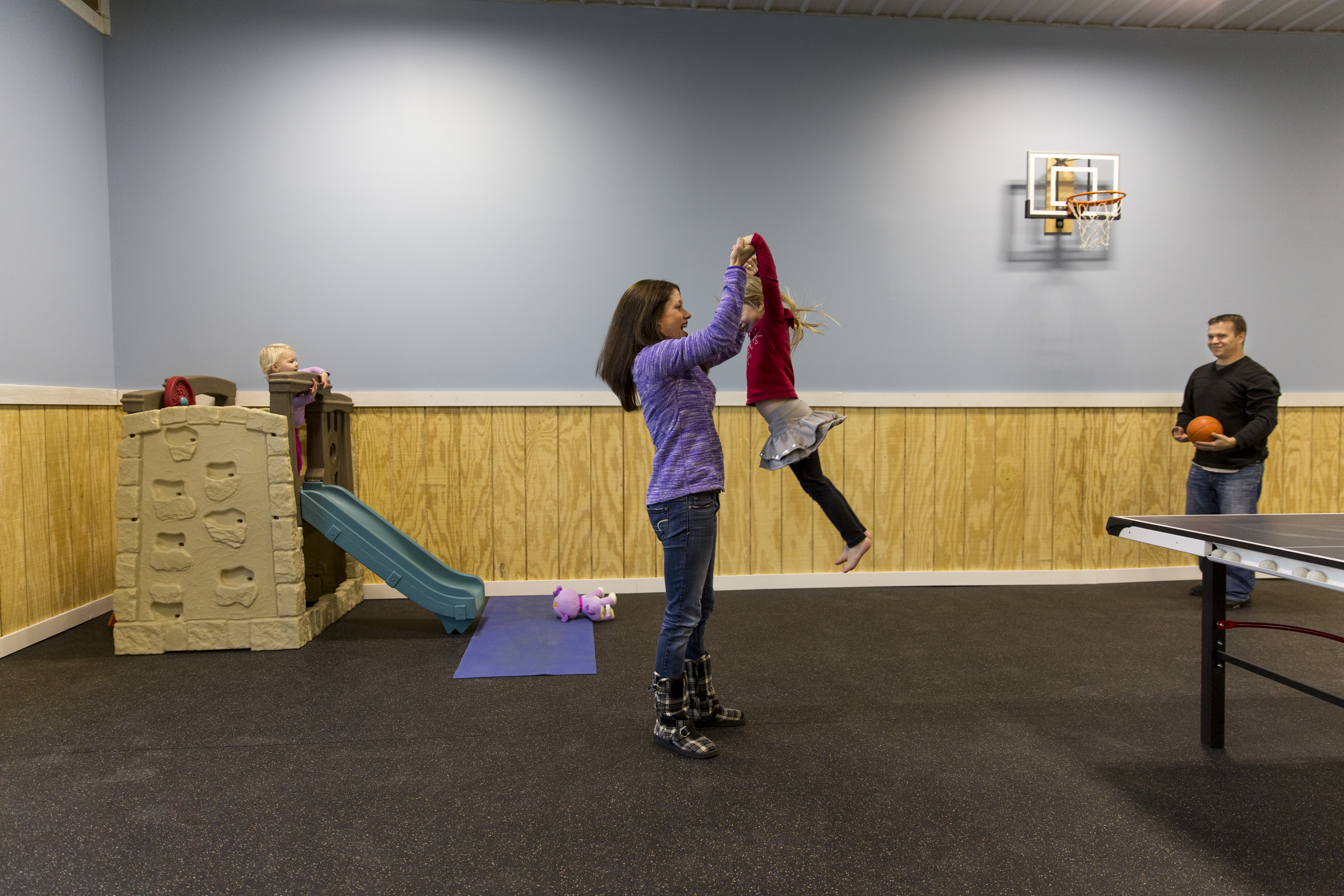 family playing in pole barn recreation room