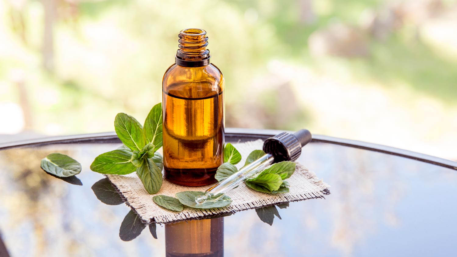 Peppermint essential oil in brown medical pipette bottle