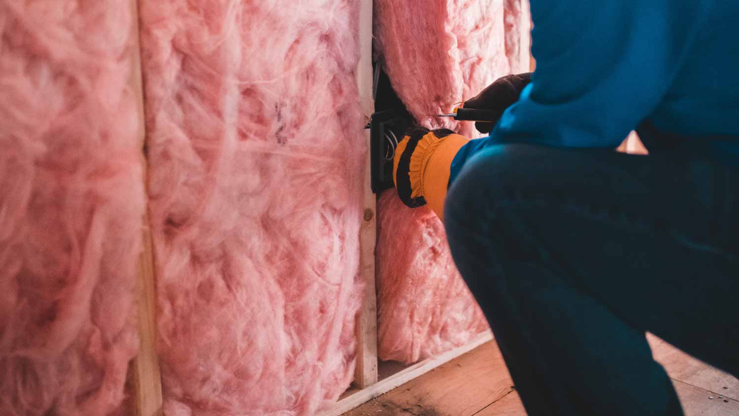 Person installing insulation