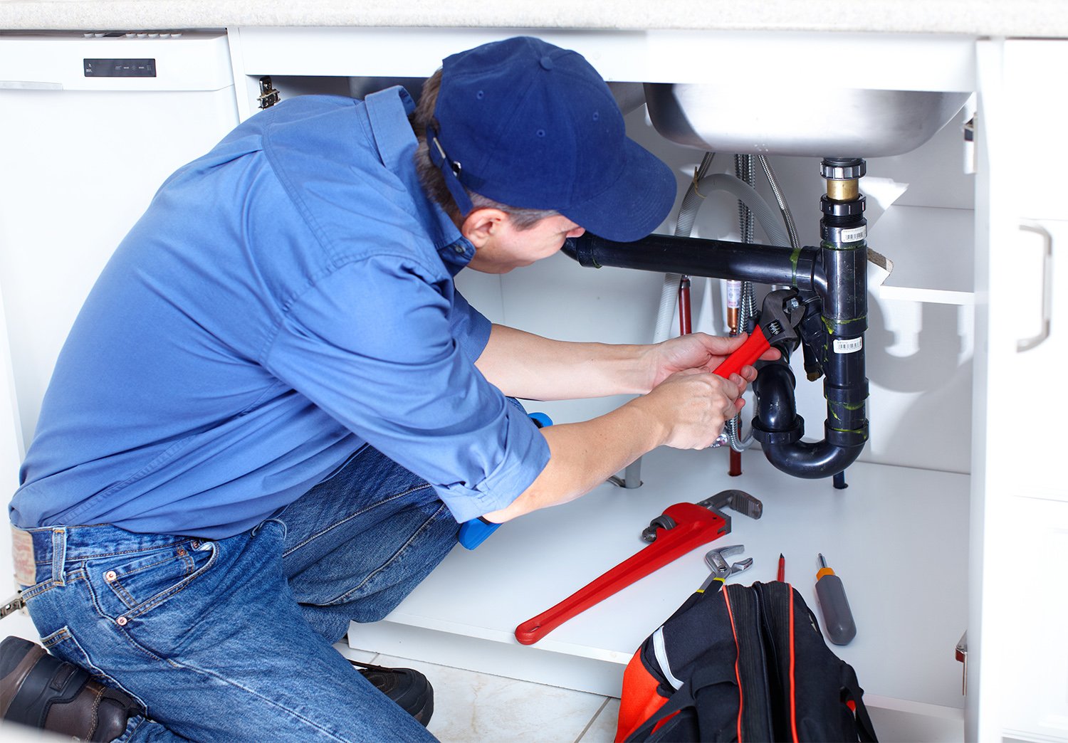 Plumber fixing sink pipes