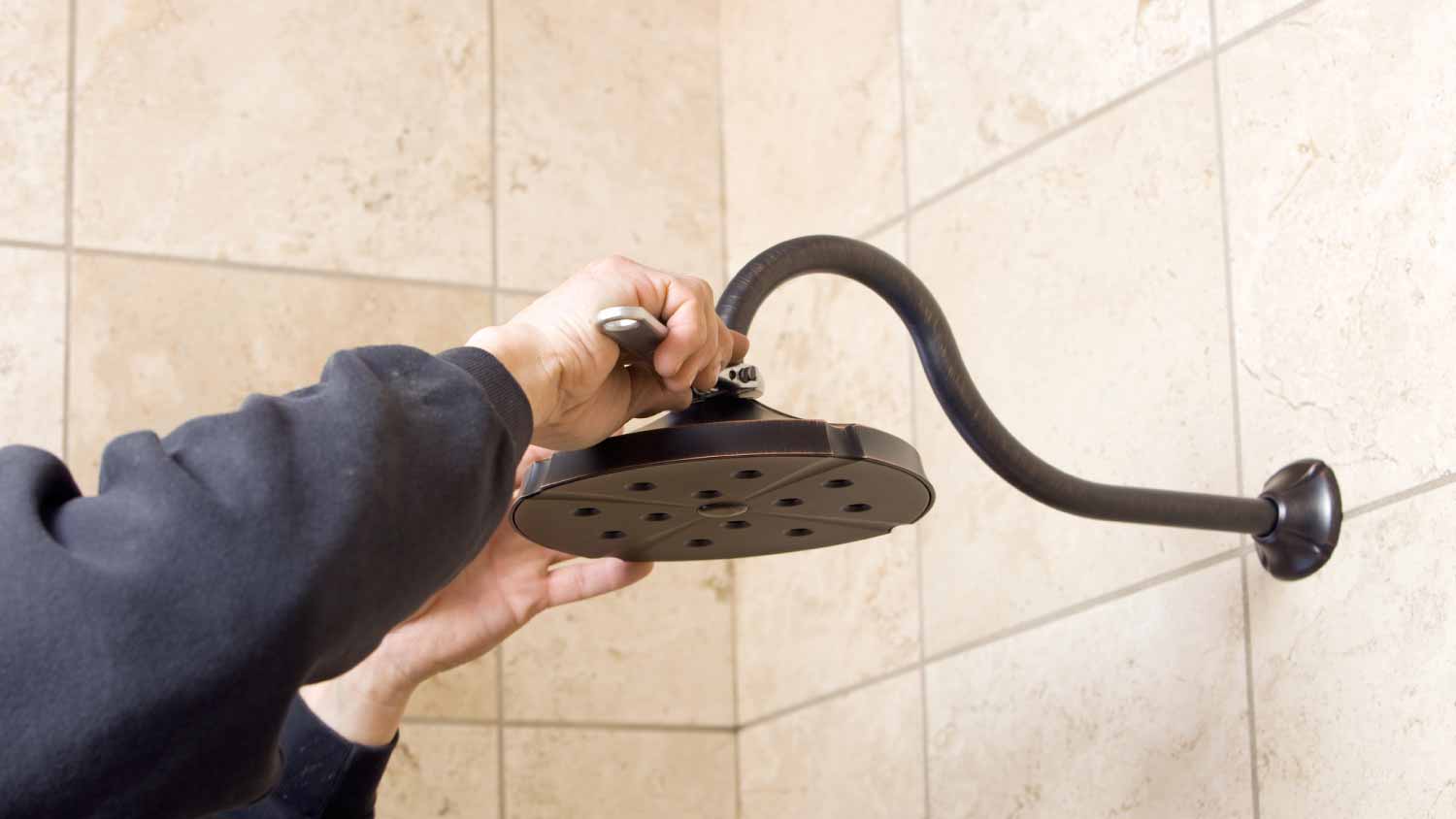 Plumber installing shower head