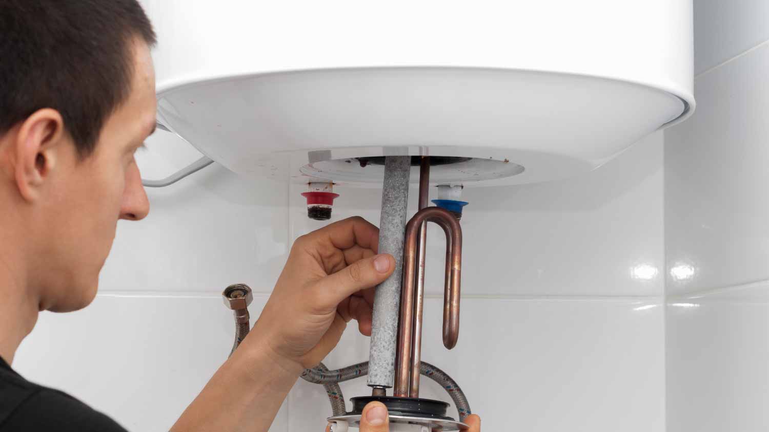 Plumber repairing boiler 