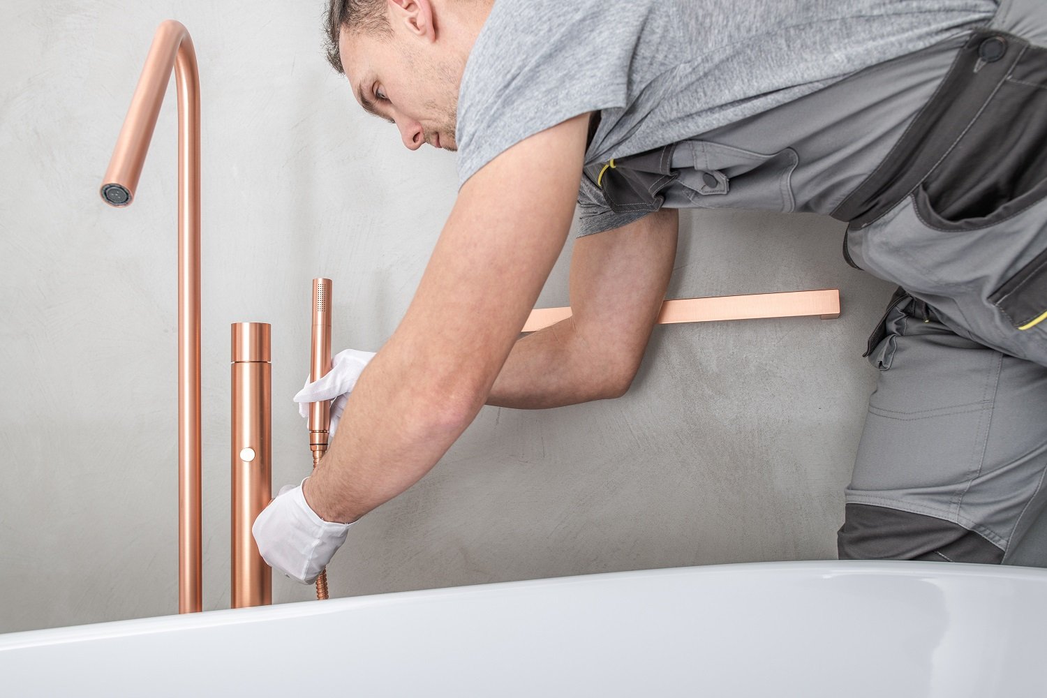 Professional installing bathtub hardware