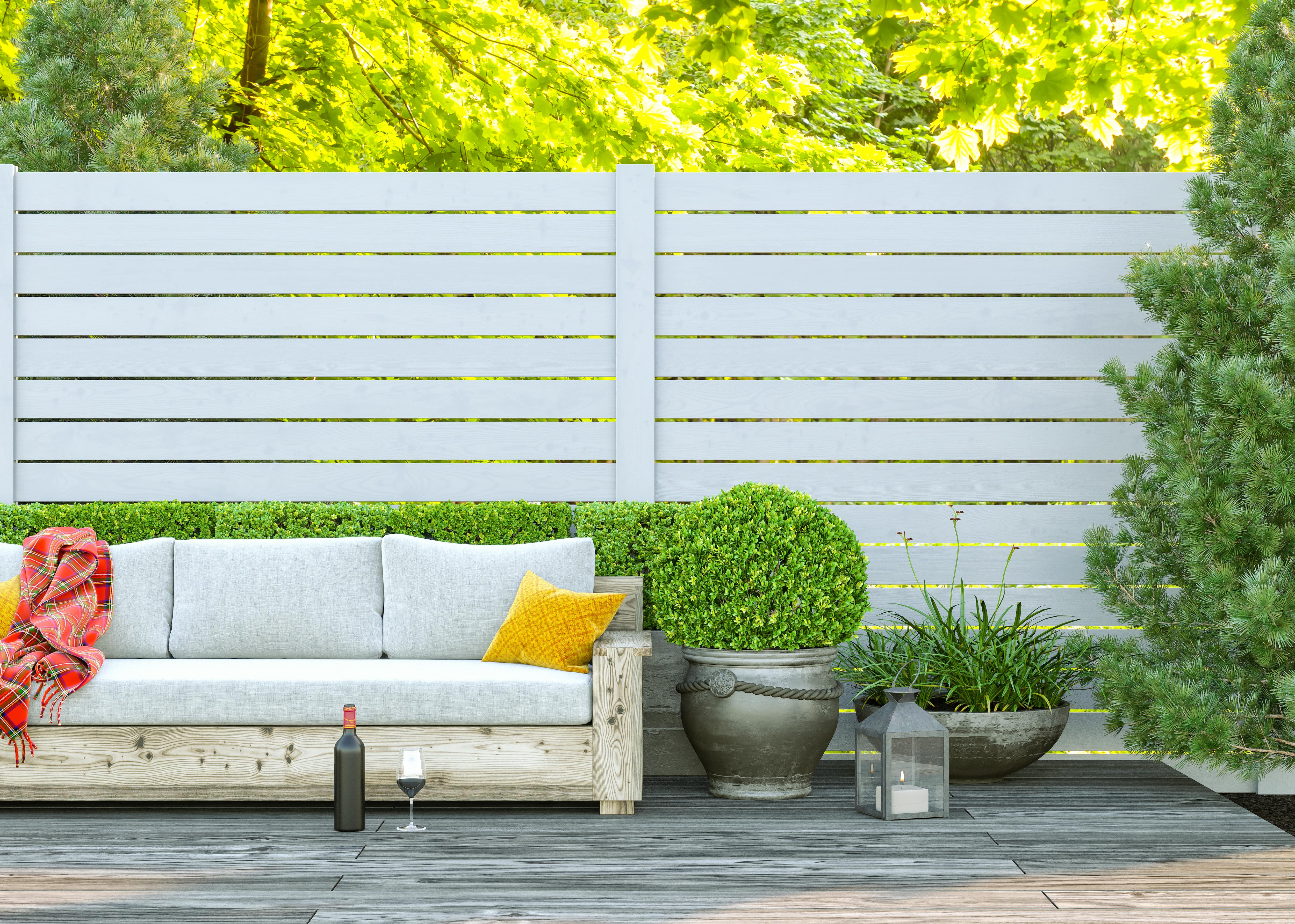 A horizontal white wood privacy fence in a backyard