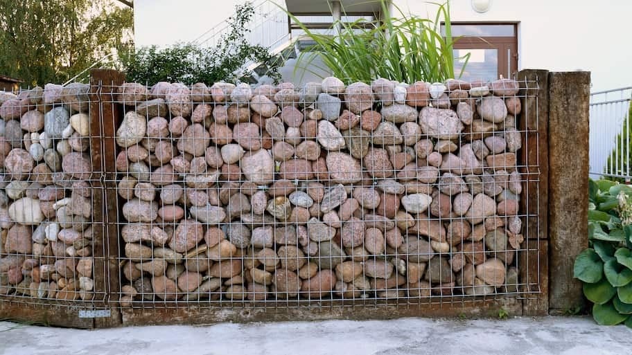 Stone wall in front of green grass