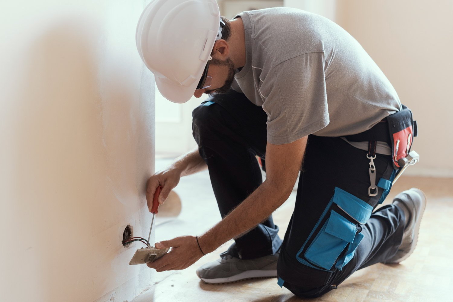 A professional electrician installing new sockets