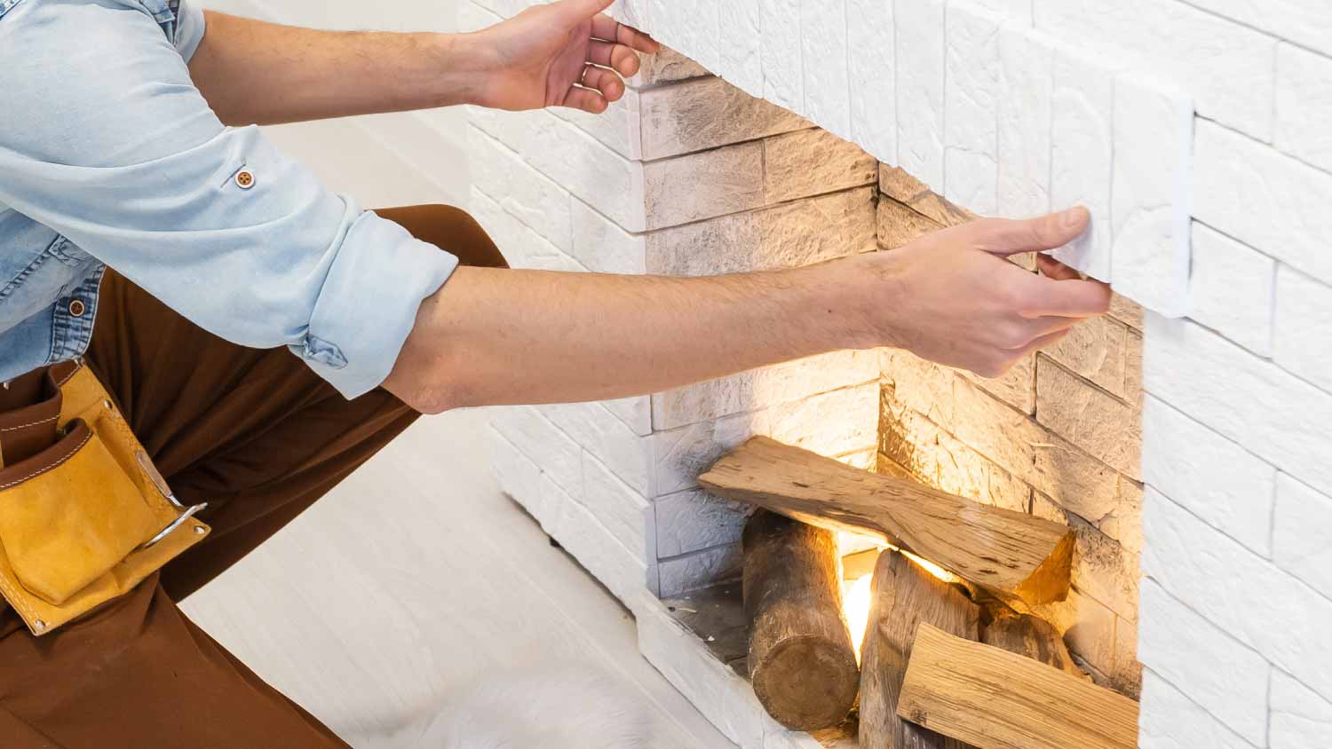 Professional technician installing fireplace 