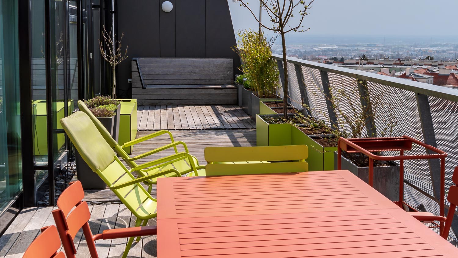 Rooftop terrace with green and terracotta furniture