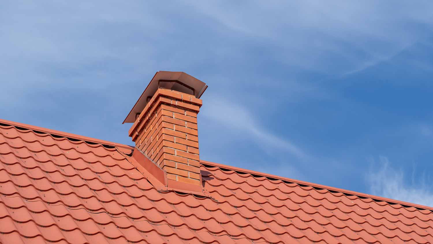 Red roof of a detached house and chimney