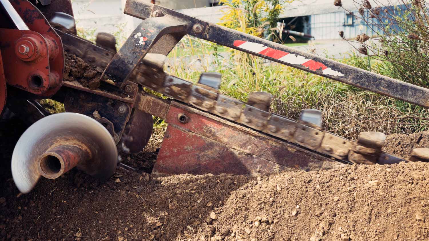 Red trenching machine in action