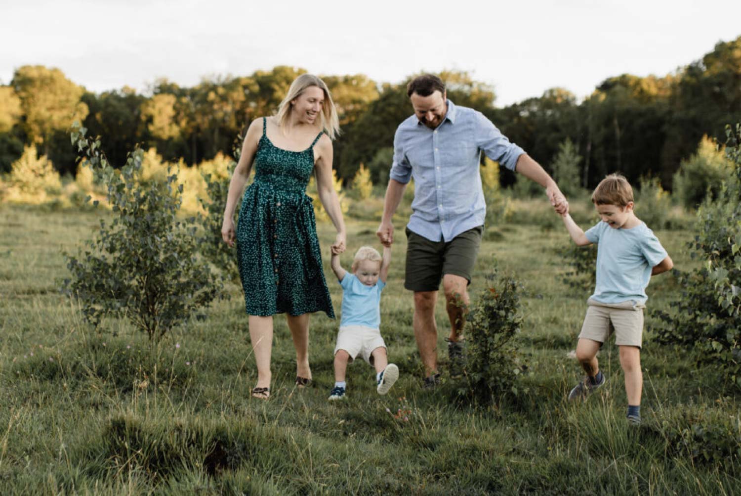 Family walking in open field