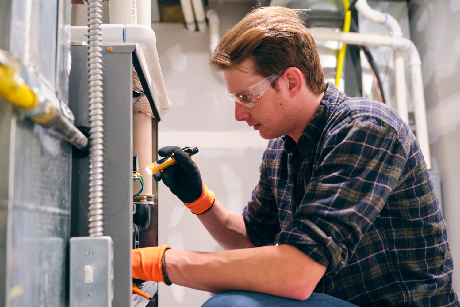 A repairman working on a furnace