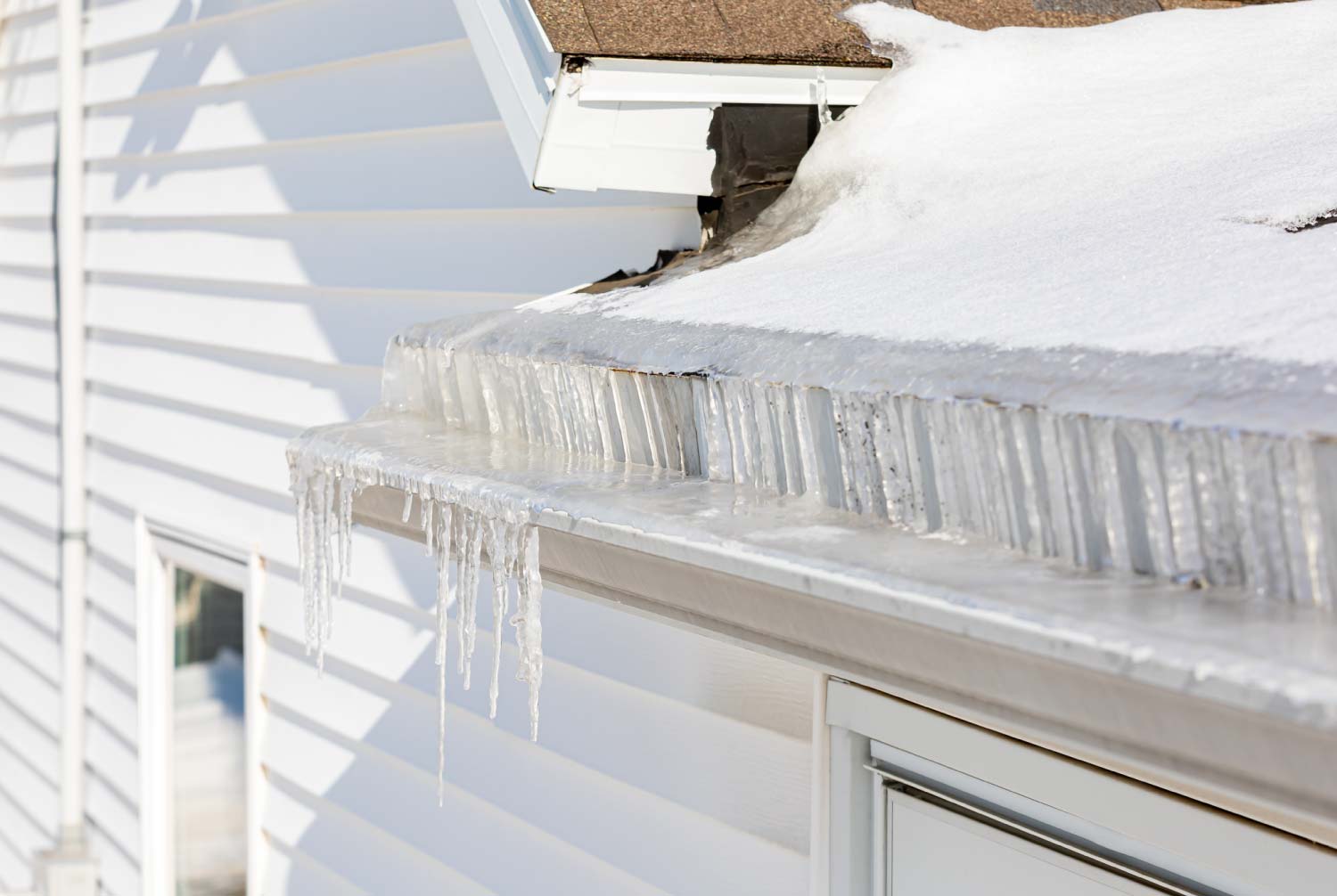 Roof gutters full of ice after a winter storm