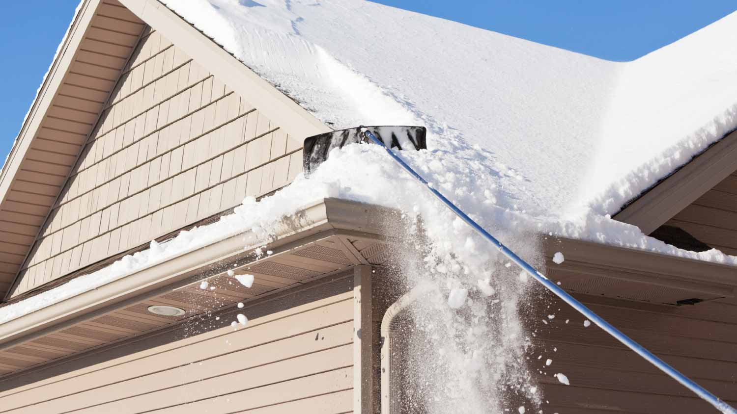 Roof rake removing winter snow