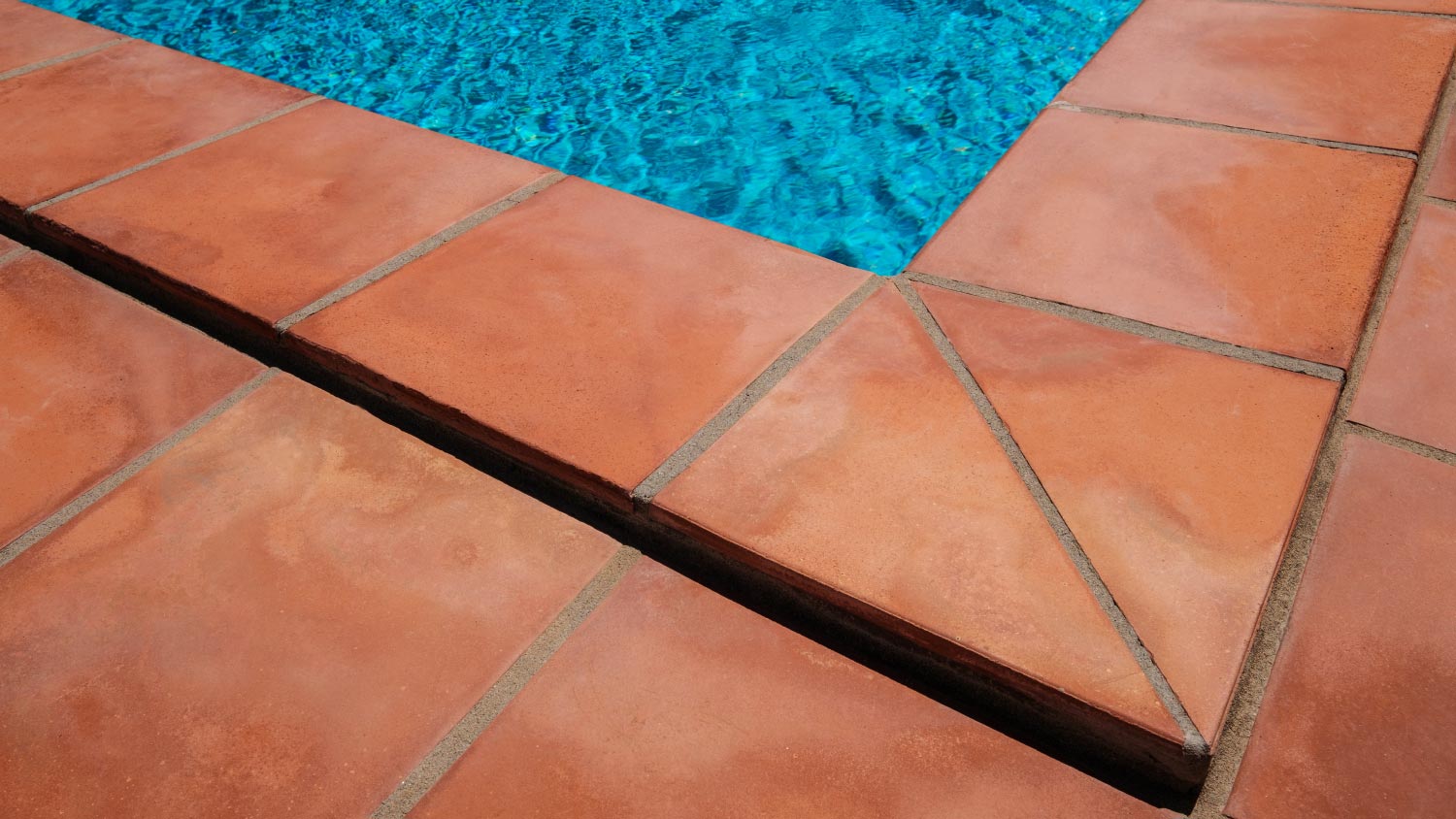 Swimming pool border and tiled terrace floor