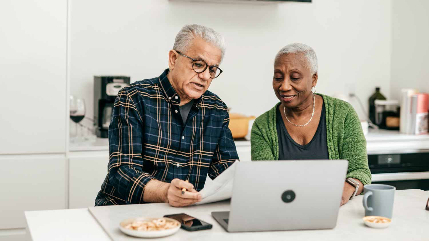 Senior couple checking bills