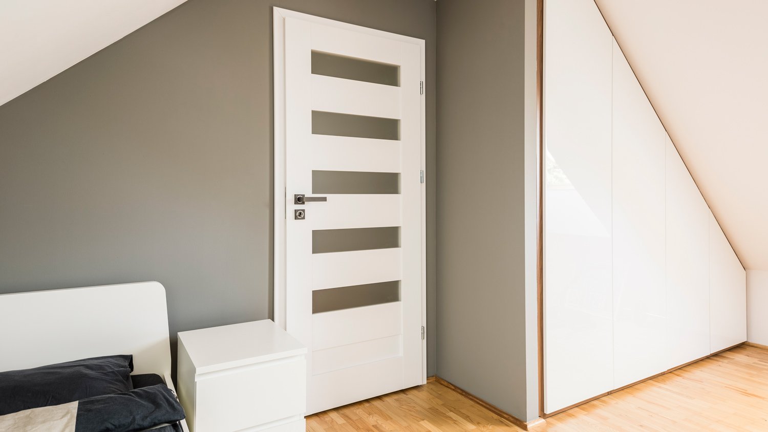 Attic bedroom with slanted storage unit
