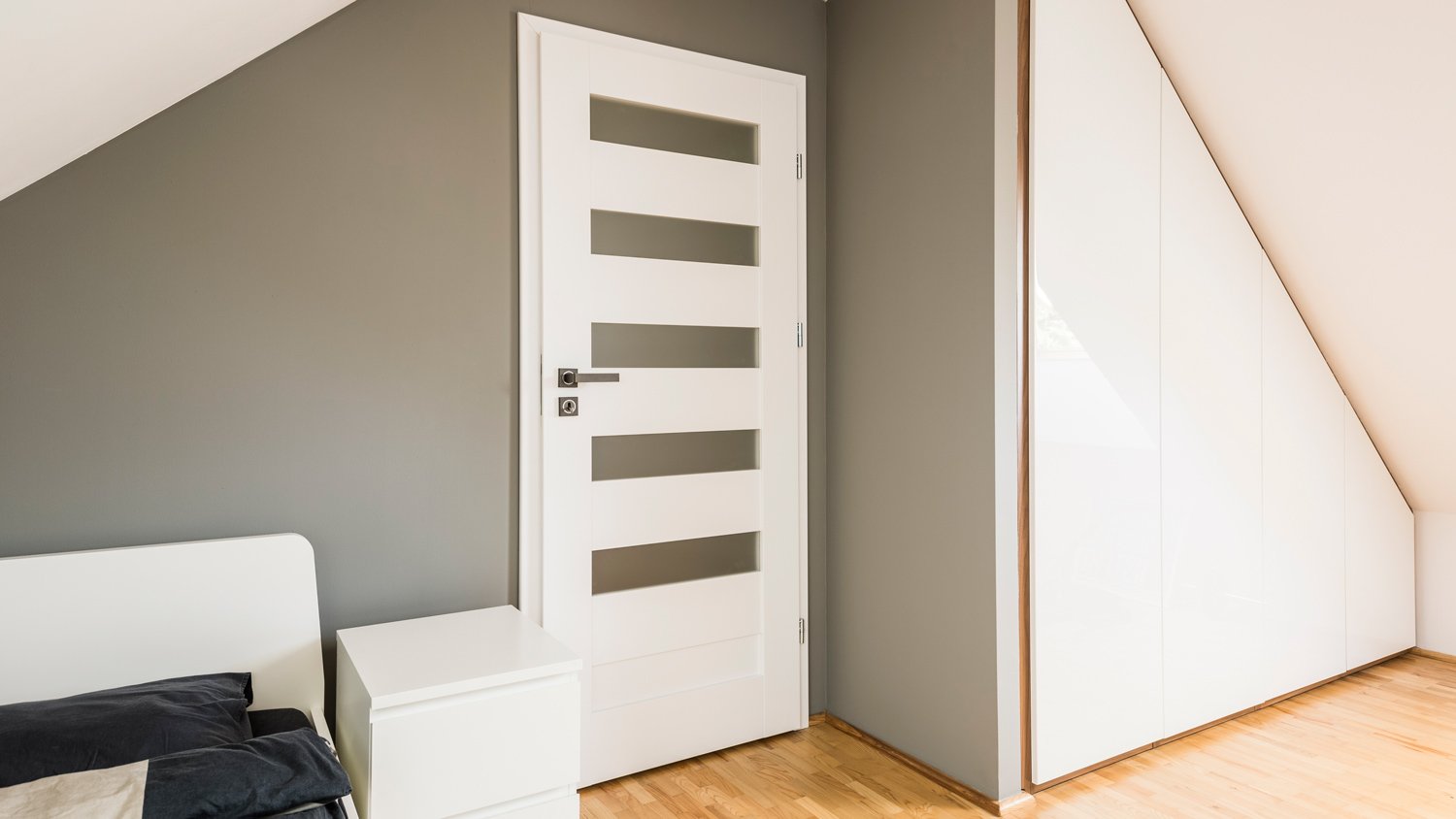 Attic bedroom with slanted storage unit 