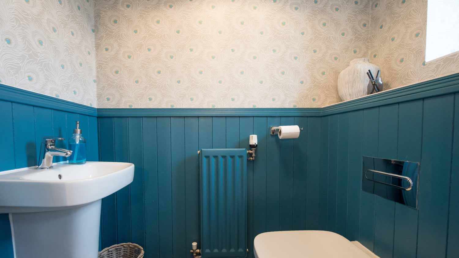 Small toilet with pattern wallpaper