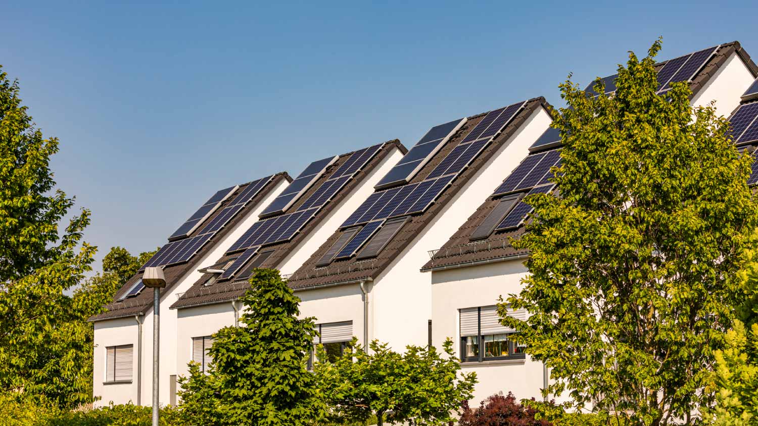 Solar panels on roofs of modern suburban houses