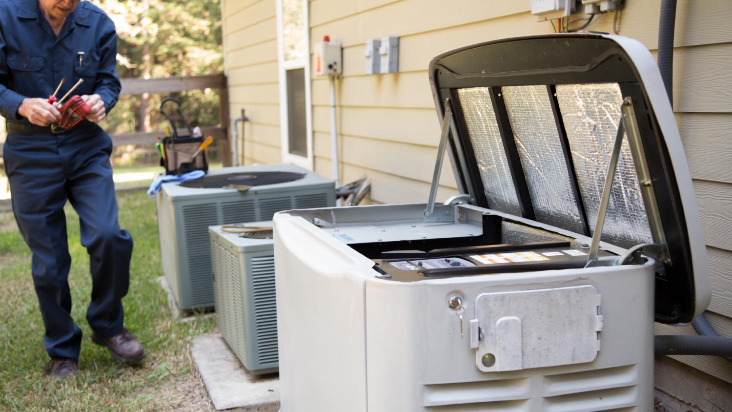 Technician checking outside generator