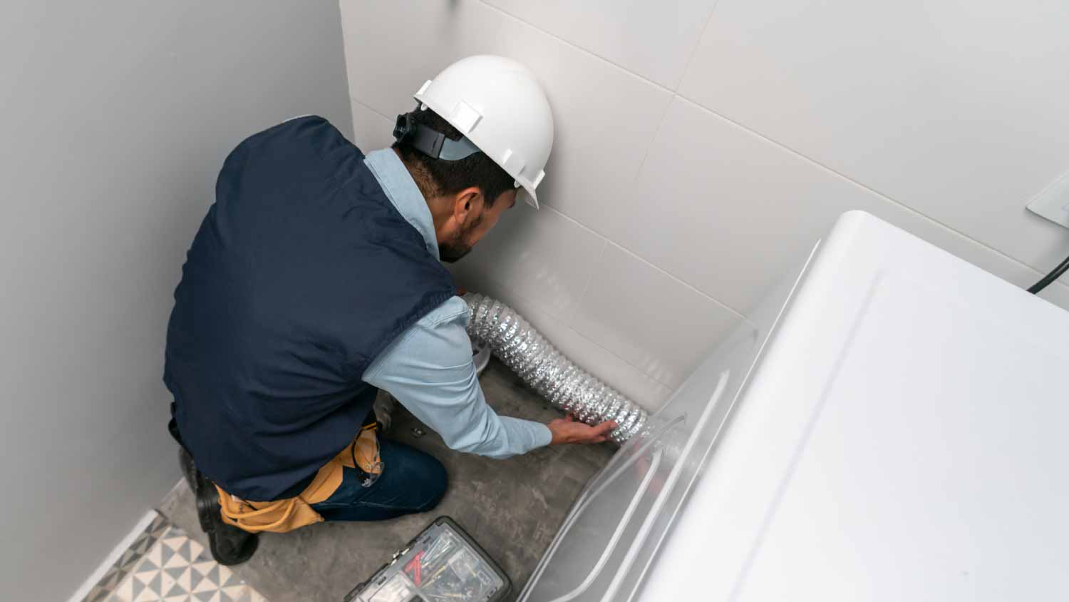 Technician installing a dryer machine