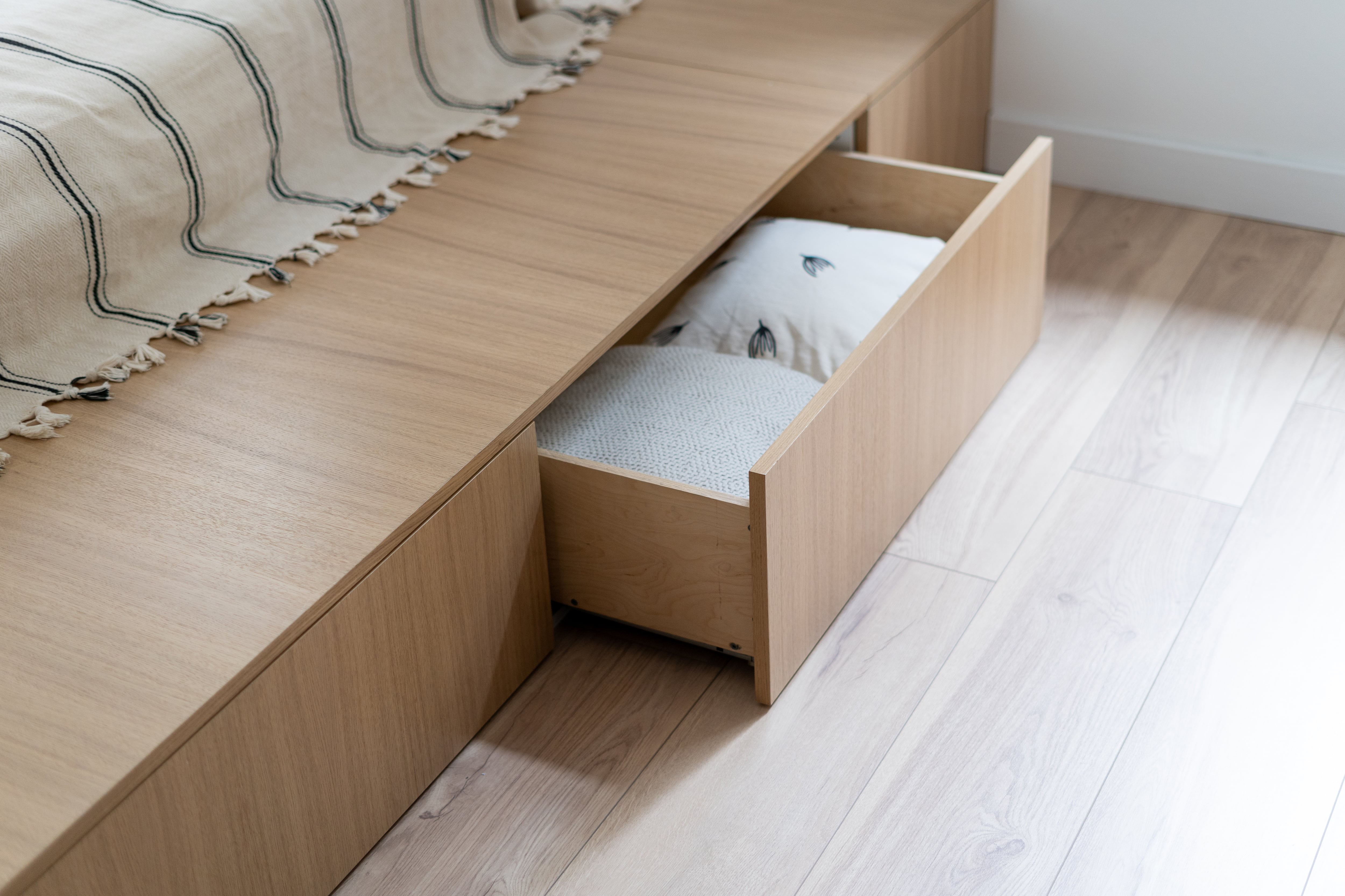 A bed frame with built-in storage drawers underneath