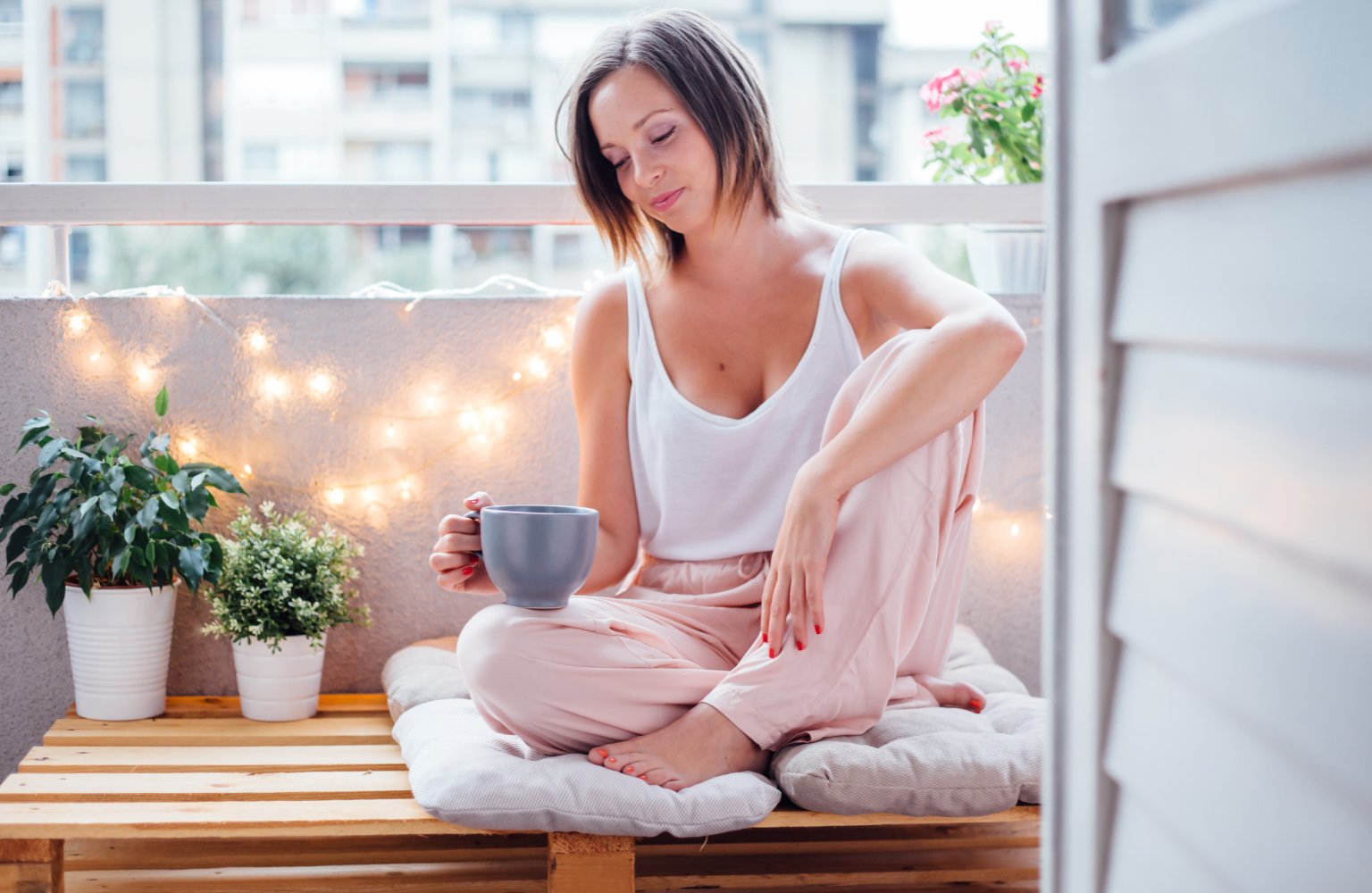 woman drinking coffee on outdoor patio