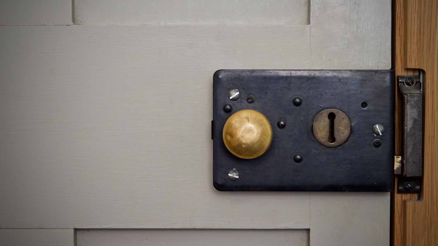 Vintage Victorian rim lock on a gray door