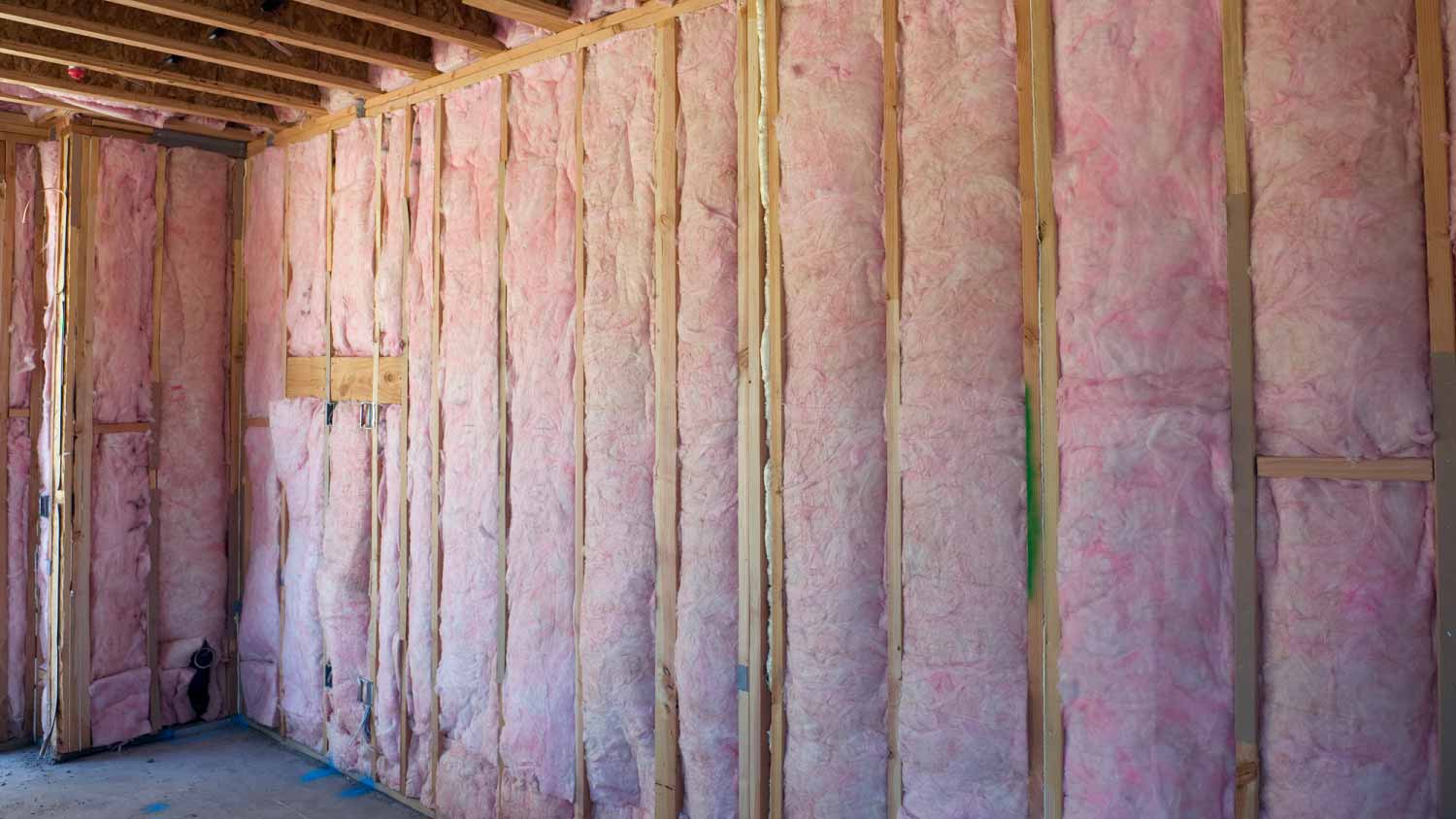 Wall of pink insulation in house