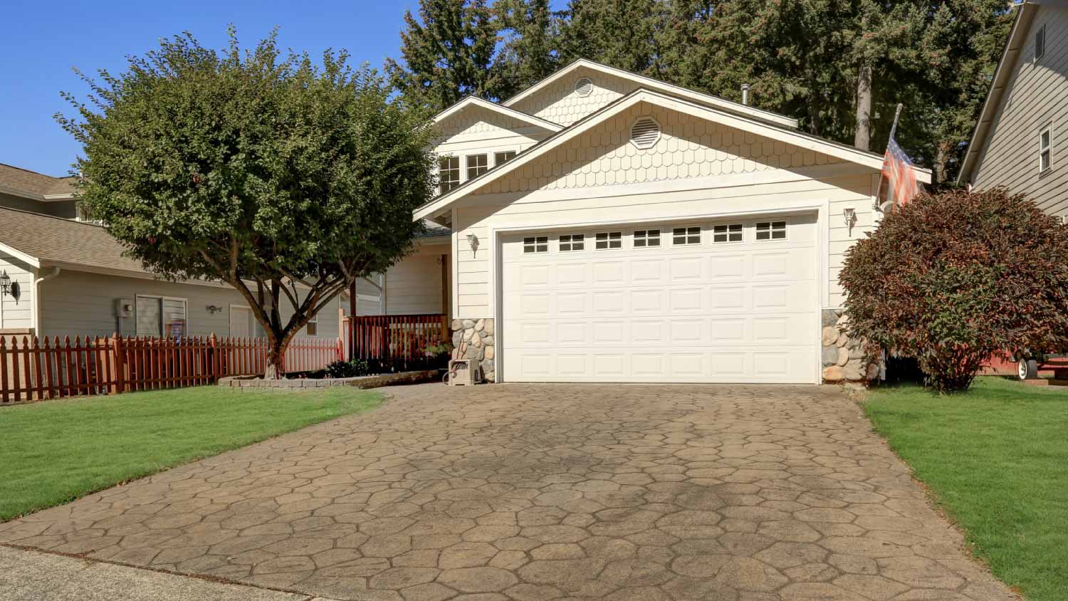 White garage exterior with a driveway