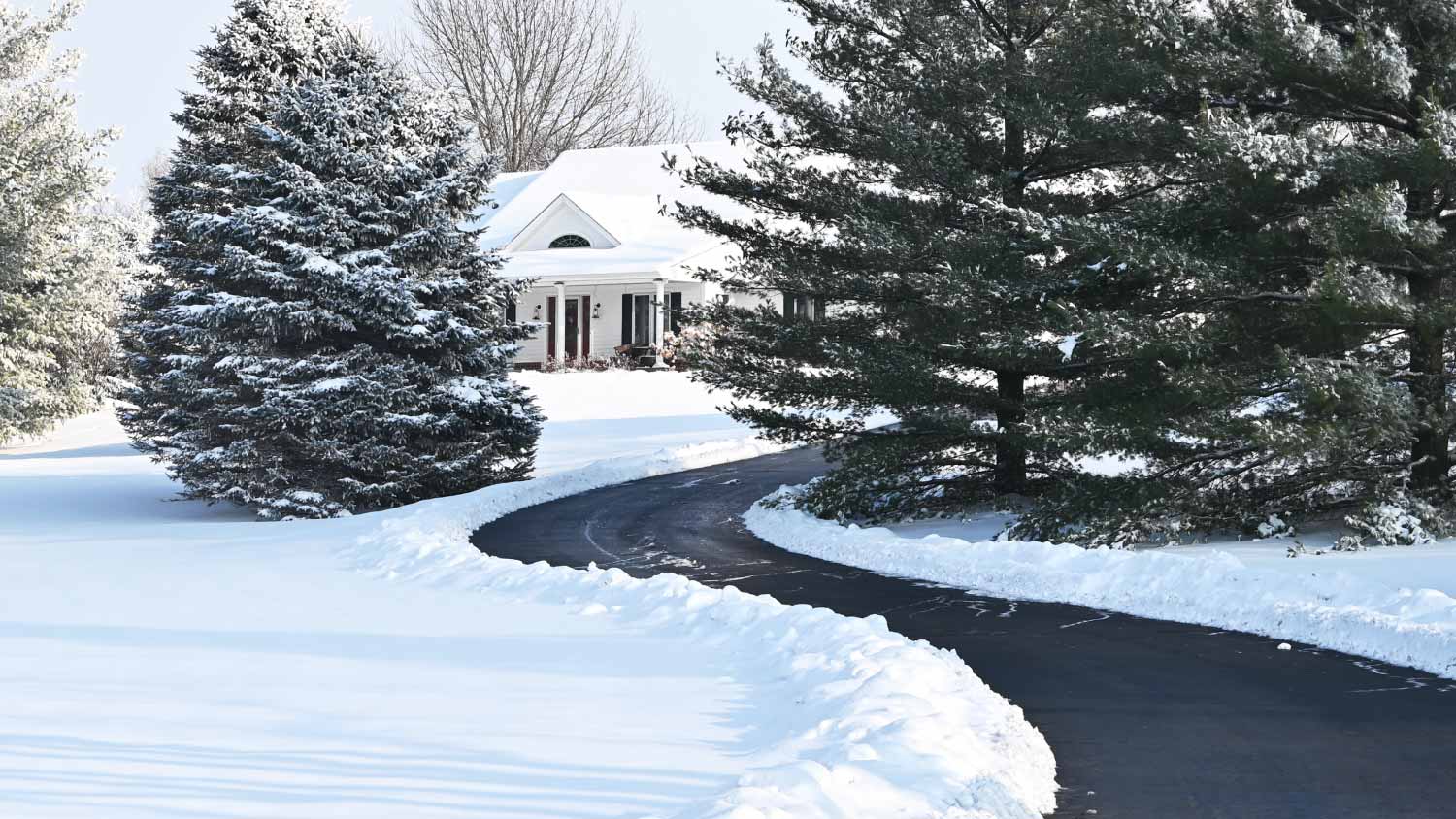 White house and driveway in winter